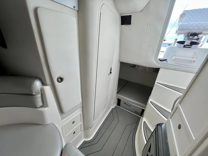 Slide: The Image of 2005 Century 3200 Walk-Around cabin interior with sleek white design and seating. - 38