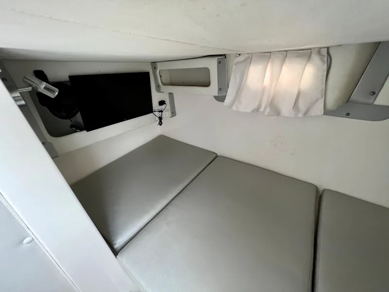 Slide: The Image of 2005 Century 3200 Walk-Around cabin interior with cushioned seating and storage. - 39