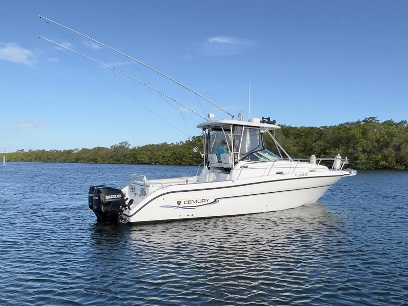 Slide: The Image of 2005 Century 3200 Walk-Around boat on calm water, clear sky background. - 4