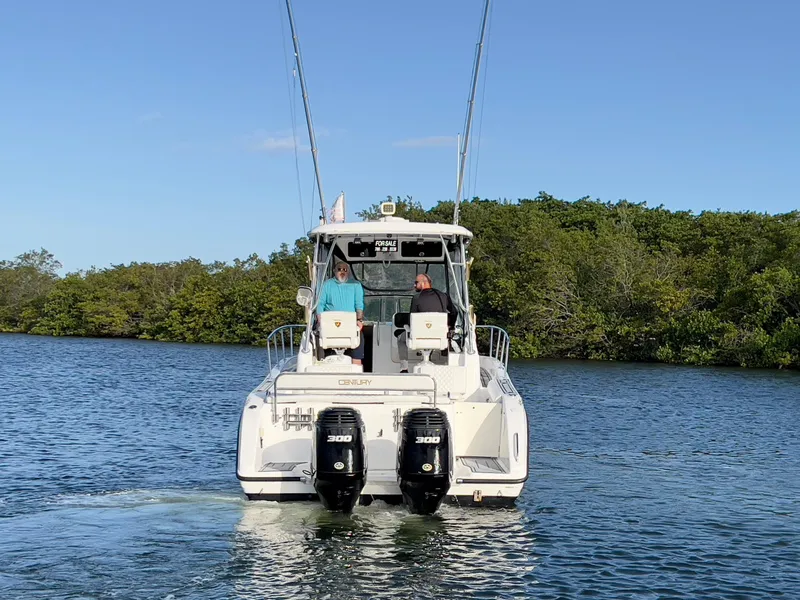 Slide: The Image of 2005 Century 3200 Walk-Around boat cruising on a calm lake. - 5