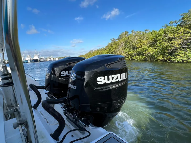 Slide: The Image of 2005 Century 3200 Walk-Around with twin Suzuki outboard motors on a sunny day. - 6