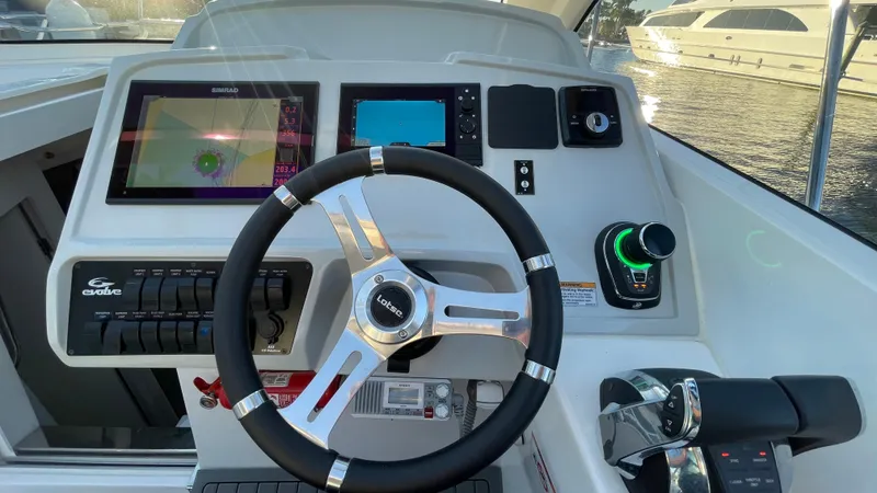 Slide: The Image of Evolve 400HT 2022 boat dashboard with steering wheel and navigation controls. - 11