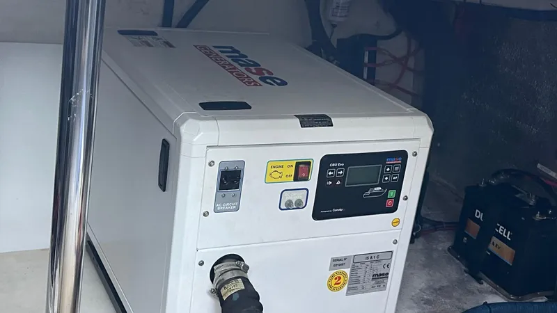 Slide: The Image of Evolve 400HT generator, 2022 model, in a utility room setting. - 16