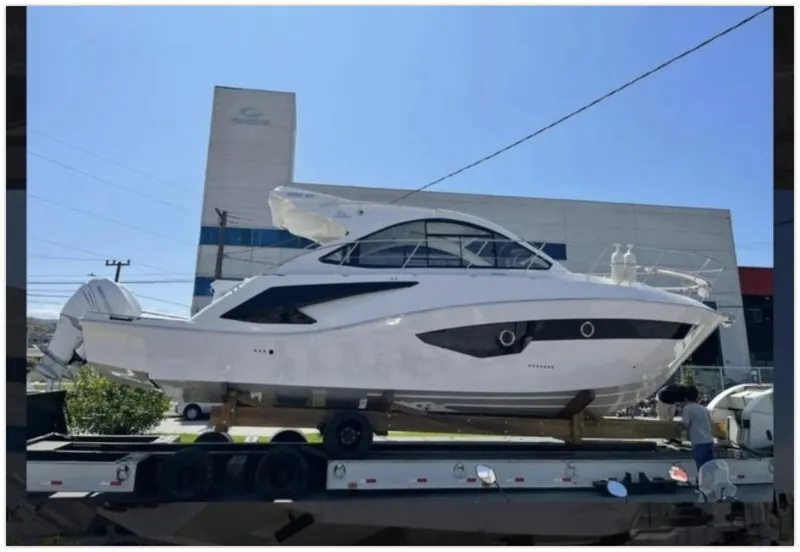Slide: The Image of 2022 Evolve 400HT yacht on trailer, displayed outdoors. - 2