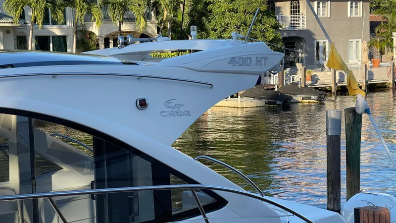 Slide: The Image of Evolve 400HT 2022 yacht docked by waterfront homes. - 6