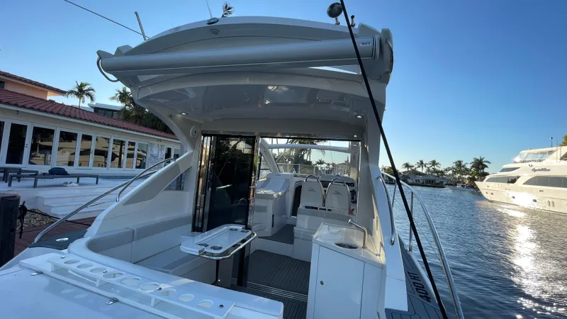 Slide: The Image of 2022 Evolve 400HT yacht docked by waterfront homes, sunny day. - 8