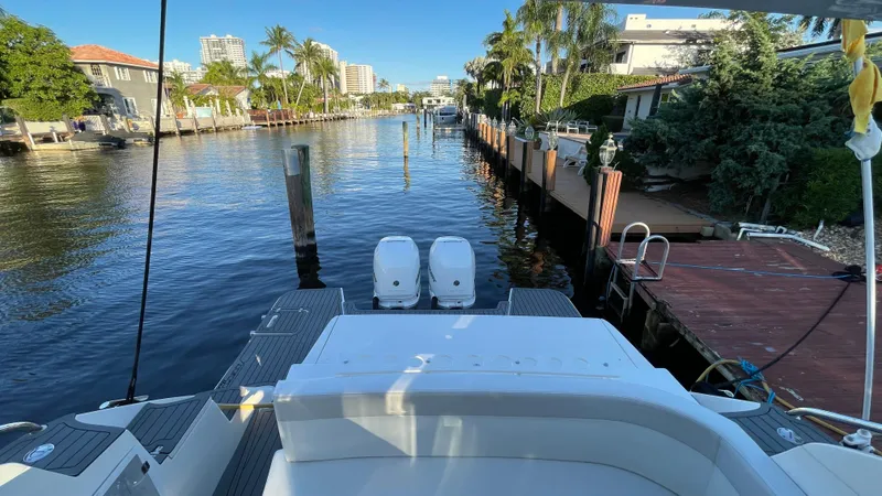 Slide: The Image of 2022 Evolve 400HT yacht docked in a scenic canal with palm trees. - 9