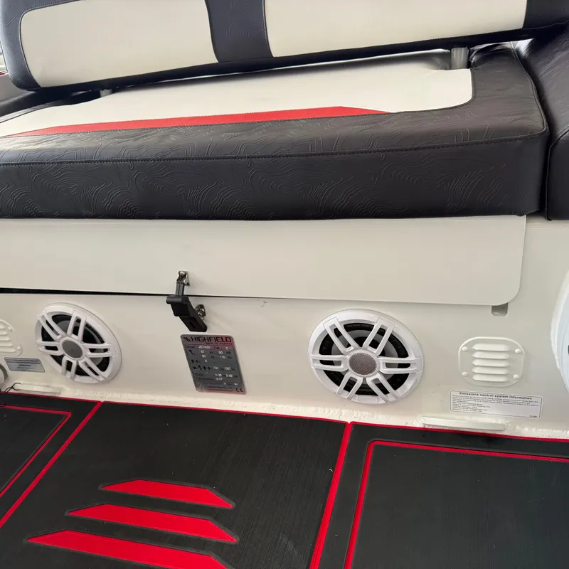 Slide: The Image of Interior seating of 2025 Highfield 420 Velox boat with speakers and red accents. - 10