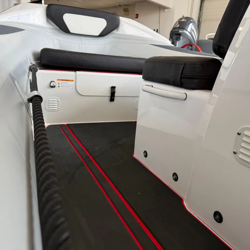 Slide: The Image of 2025 Highfield 420 Velox boat interior with black seating and red accents. - 11