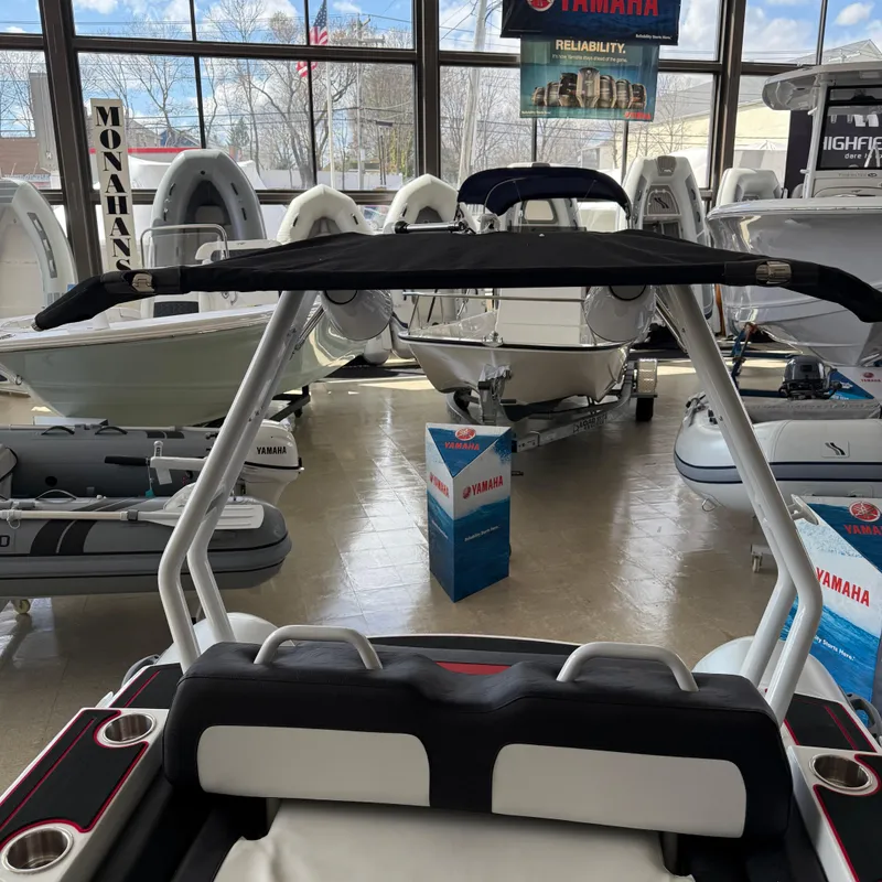 Slide: The Image of 2025 Highfield 420 Velox boat displayed in a showroom with Yamaha branding. - 13