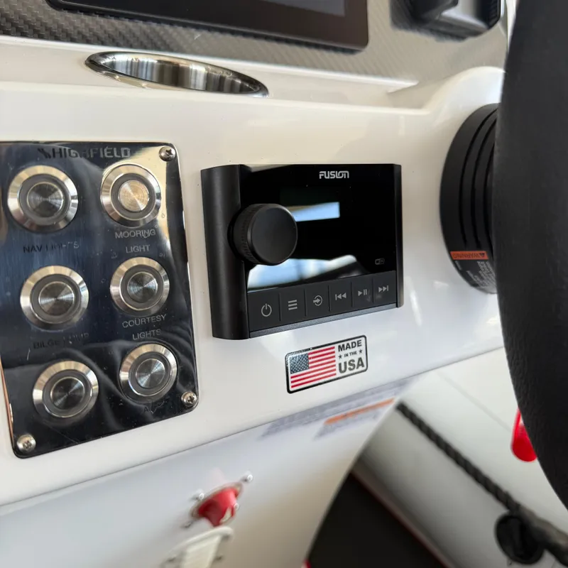 Slide: The Image of Control panel of 2025 Highfield 420 Velox boat with audio system and USA label. - 14