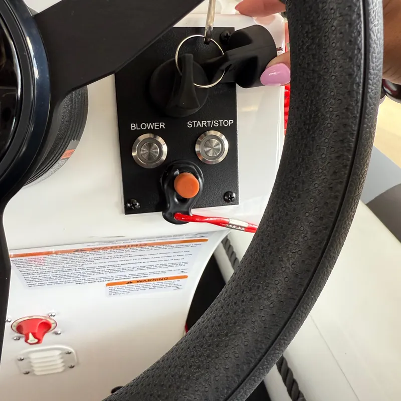 Slide: The Image of Steering wheel and control panel of 2025 Highfield 420 Velox boat. - 16