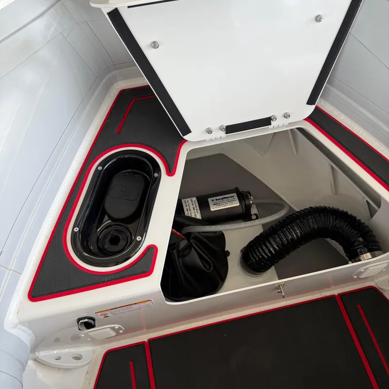Slide: The Image of 2025 Highfield 420 Velox boat storage compartment with red trim and equipment. - 18