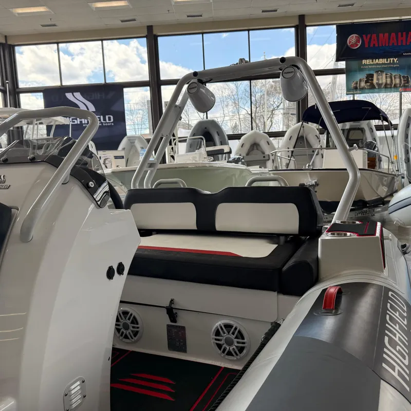 Slide: The Image of 2025 Highfield 420 Velox boat displayed in a showroom with Yamaha branding. - 2