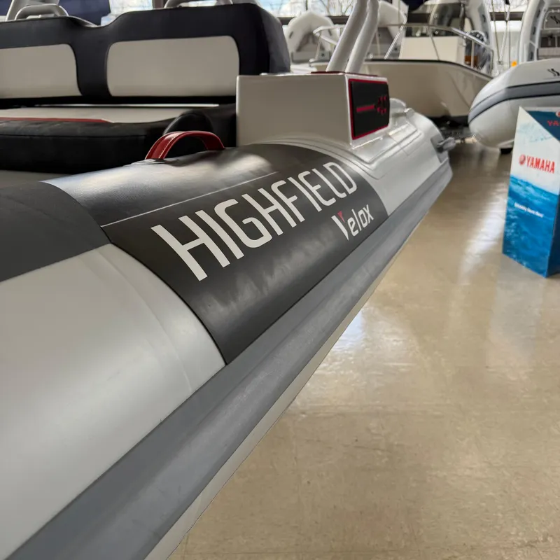 Slide: The Image of 2025 Highfield 420 Velox boat displayed indoors, showcasing sleek design and branding. - 21