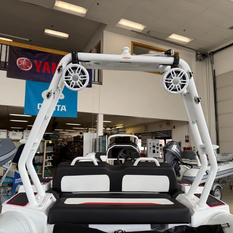 Slide: The Image of 2025 Highfield 420 Velox boat interior with speakers and seating in showroom. - 3