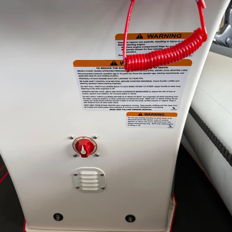 Slide: The Image of Control panel of a 2025 Highfield 420 Velox boat with safety warnings and red cord. - 5