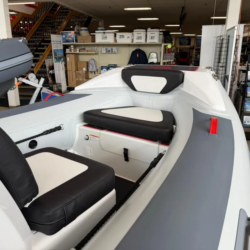 Slide: The Image of 2025 Highfield 420 Velox boat interior with black and white seating in a showroom. - 7