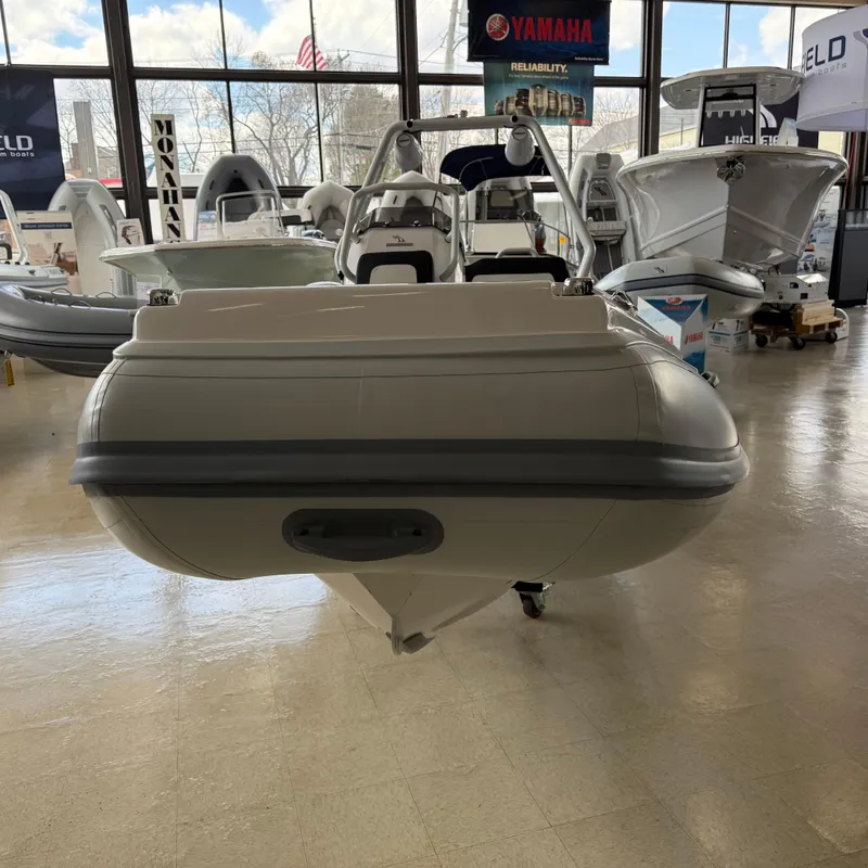 Slide: The Image of 2025 Highfield 420 Velox boat displayed in a showroom with other vessels. - 8