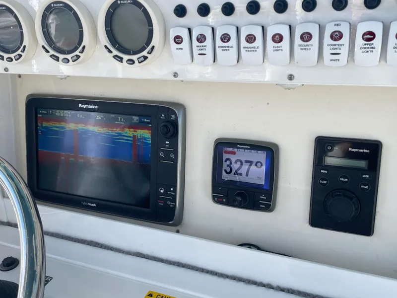 Slide: The Image of Boat dashboard with Raymarine electronics on a 2008 Everglades 350CC. - 13