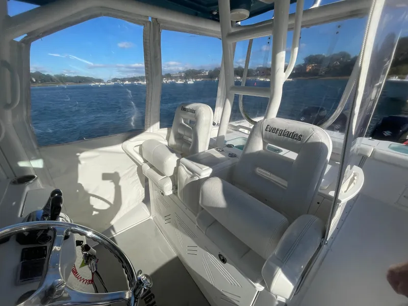 Slide: The Image of Interior of 2008 Everglades 350CC boat with white seating and steering wheel. - 14