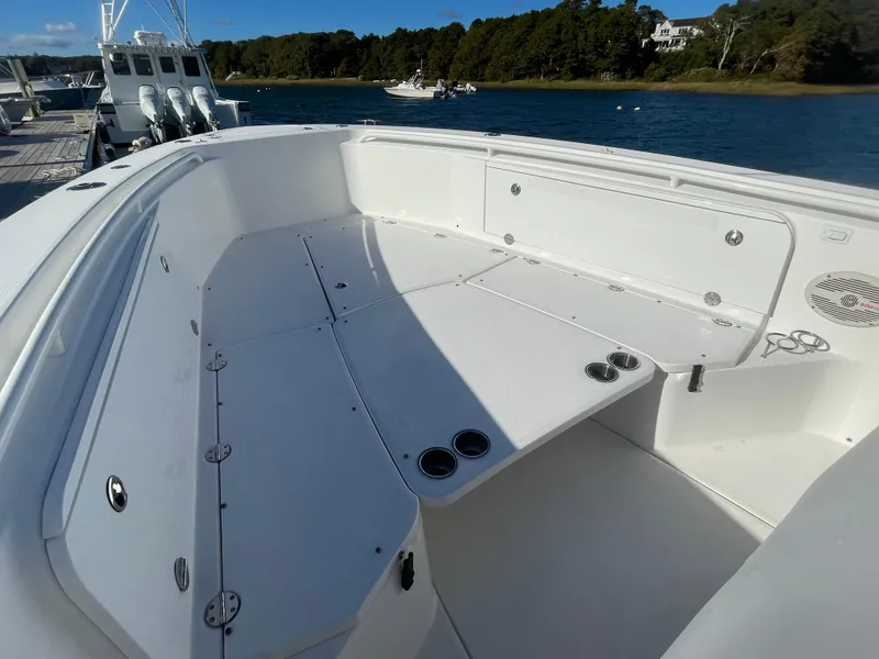 Slide: The Image of 2008 Everglades 350CC boat interior, spacious seating, docked by a scenic waterfront. - 15