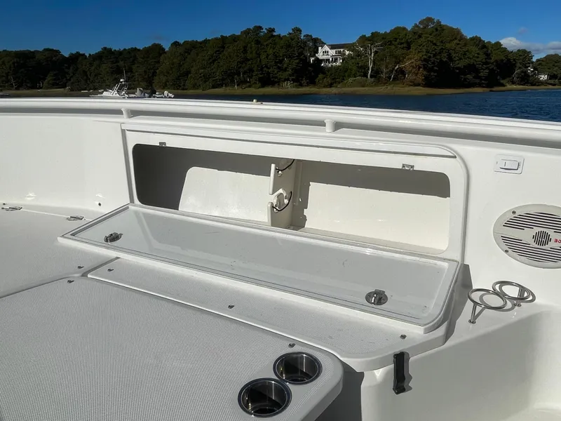 Slide: The Image of 2008 Everglades 350CC boat interior with open storage compartment and cup holders. - 16