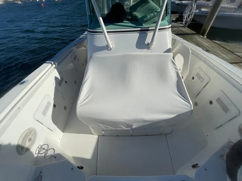Slide: The Image of 2008 Everglades 350CC boat interior with covered seating, docked by the water. - 17