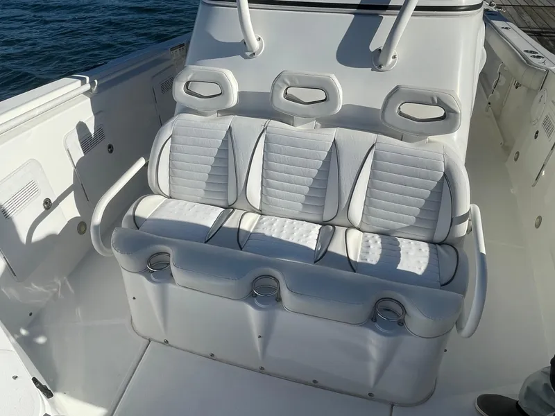 Slide: The Image of 2008 Everglades 350CC boat seating with white cushioned seats and cup holders. - 18