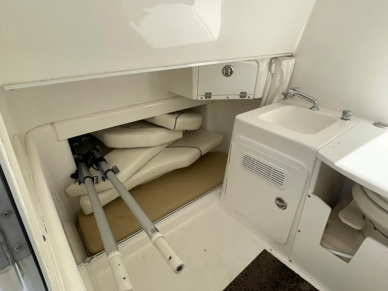Slide: The Image of 2008 Everglades 350CC boat interior with storage, sink, and cushions. - 20