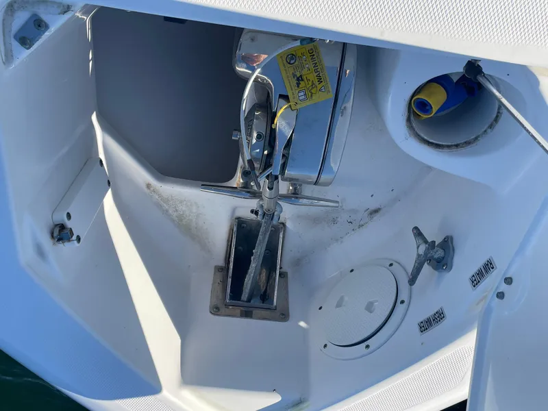 Slide: The Image of 2008 Everglades 350CC boat anchor compartment with winch and hose storage. - 21