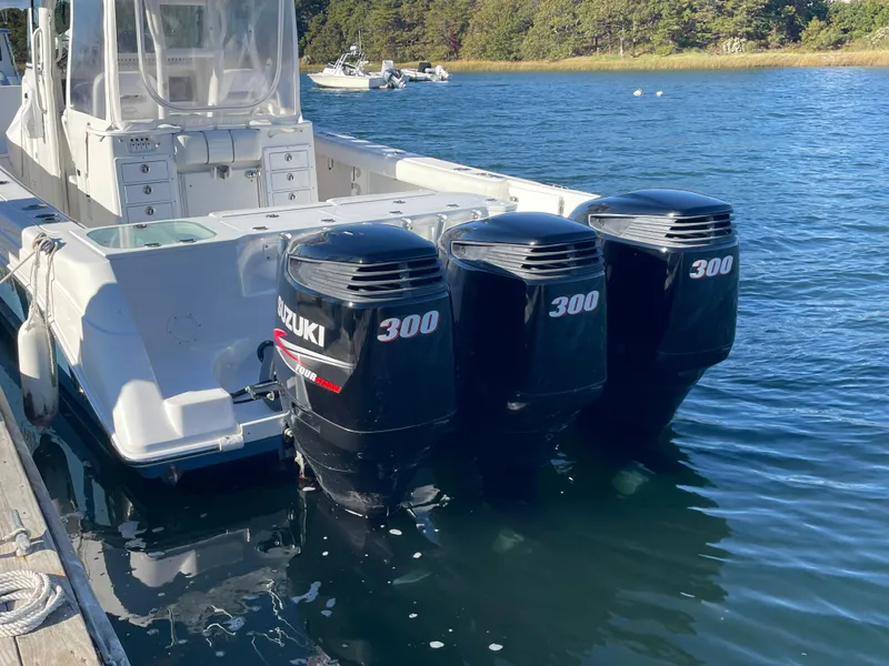 Slide: The Image of 2008 Everglades 350CC boat with triple Suzuki 300 outboard engines docked on water. - 4