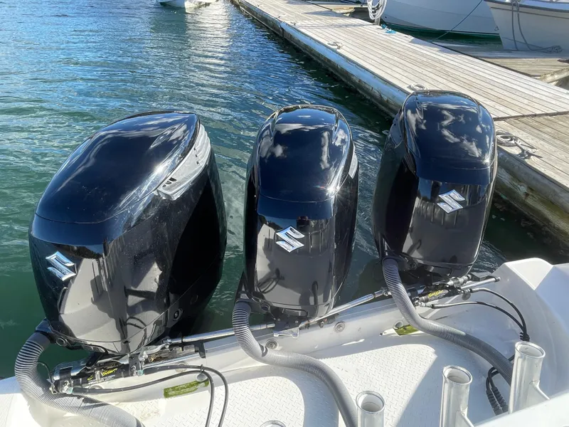 Slide: The Image of Triple Suzuki outboard motors on 2008 Everglades 350CC boat at dock. - 5
