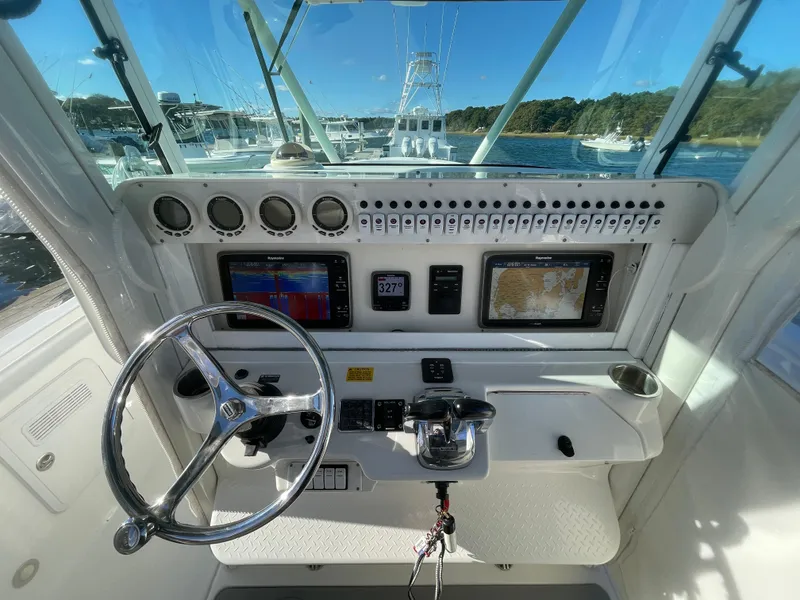 Slide: The Image of 2008 Everglades 350CC boat dashboard with steering wheel and navigation screens. - 9