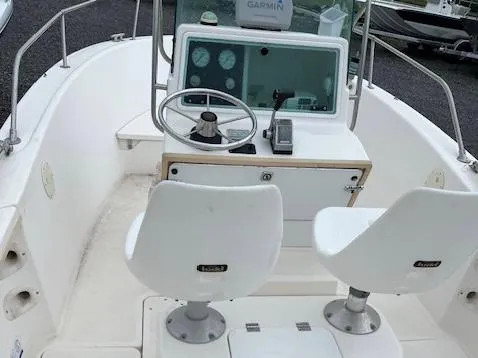 Slide: The Image of 1998 Bayliner Trophy 1903 CC boat cockpit with steering wheel and seats. - 3