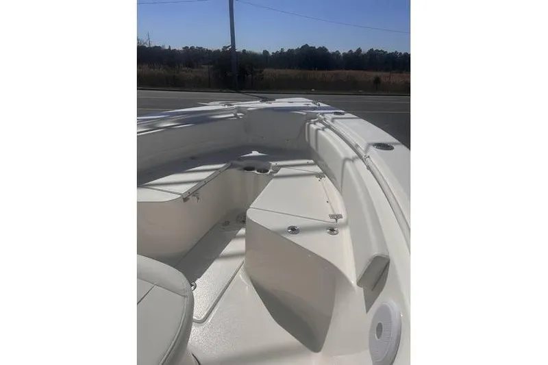 Slide: The Image of 2025 Key West 239 FS boat interior with seating and storage compartments. - 12