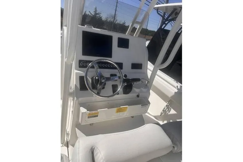 Slide: The Image of 2025 Key West 239 FS boat console with steering wheel and electronic displays. - 14