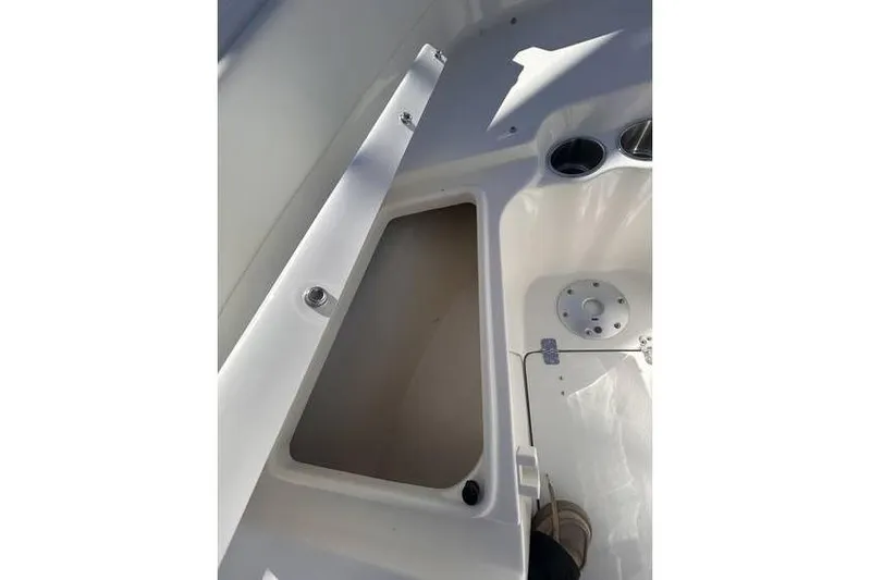 Slide: The Image of 2025 Key West 239 FS boat interior storage compartment with cup holders. - 6
