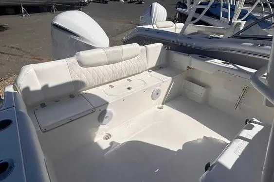 Slide: The Image of 2025 Key West 239 FS boat interior with white seating and storage compartments. - 7