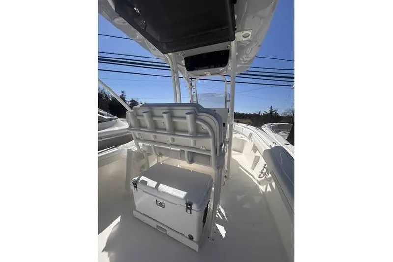 Slide: The Image of 2025 Key West 239 FS boat interior with seating and storage, under clear blue sky. - 8
