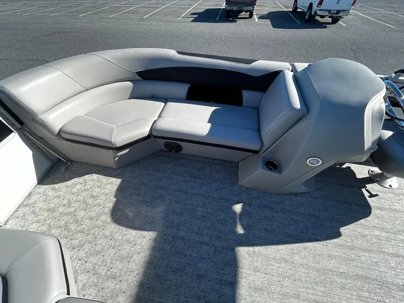 Slide: The Image of 2024 Berkshire 24RFC LE 2.75 pontoon boat interior with gray seating and carpet. - 11