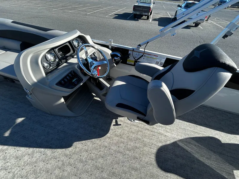 Slide: The Image of 2024 Berkshire 24RFC LE 2.75 boat cockpit with steering wheel and captain's chair. - 12