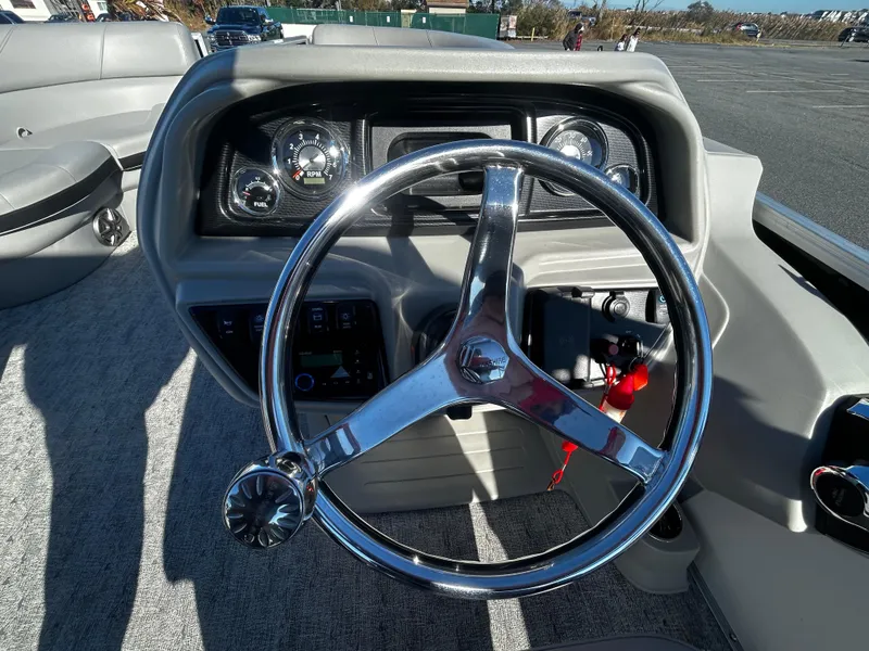 Slide: The Image of 2024 Berkshire 24RFC LE 2.75 boat steering wheel and dashboard controls. - 13