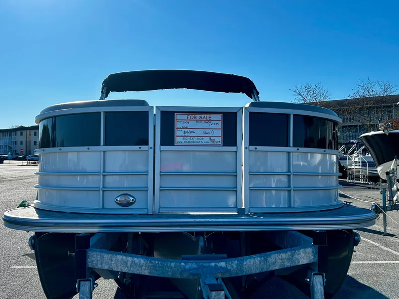 Slide: The Image of 2024 Berkshire 24RFC LE 2.75 pontoon boat for sale in parking lot. - 2