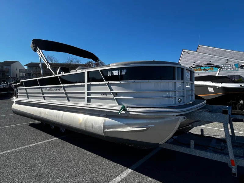 Slide: The Image of 2024 Berkshire 24RFC LE 2.75 pontoon boat parked on a trailer. - 4
