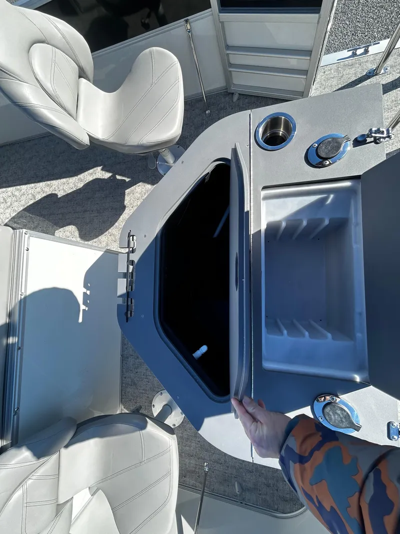 Slide: The Image of 2024 Berkshire 24RFC LE 2.75 boat interior with open storage compartment and seating. - 7