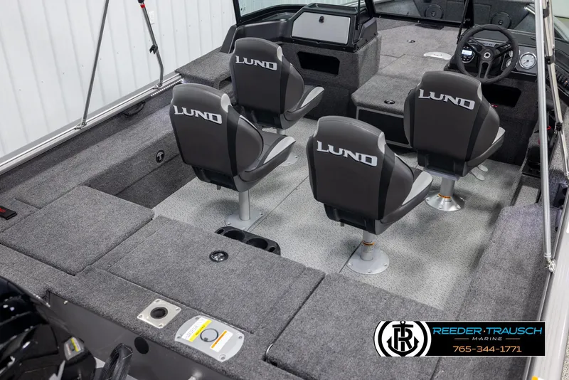 Slide: The Image of 2025 Lund 1875 Impact XS boat interior with four seats and steering console. - 11