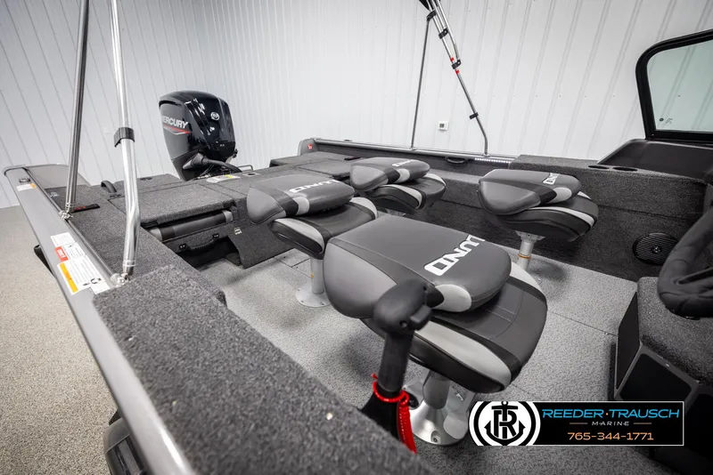 Slide: The Image of 2025 Lund 1875 Impact XS boat interior with seating and Mercury engine. - 19