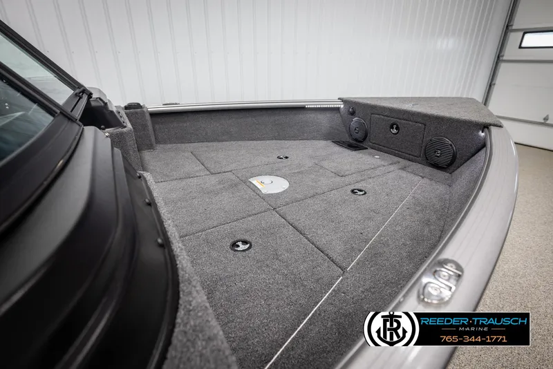 Slide: The Image of 2025 Lund 1875 Impact XS boat interior with carpeted deck and storage compartments. - 21