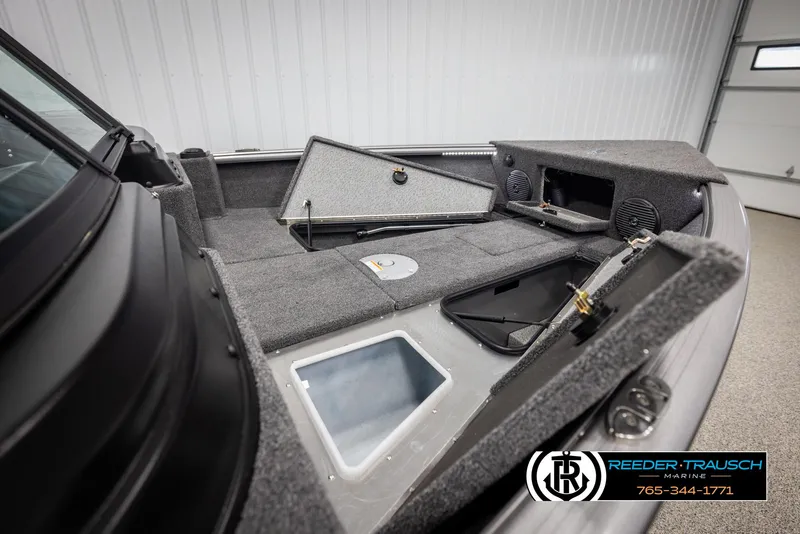 Slide: The Image of 2025 Lund 1875 Impact XS boat interior with storage compartments and speakers. - 22